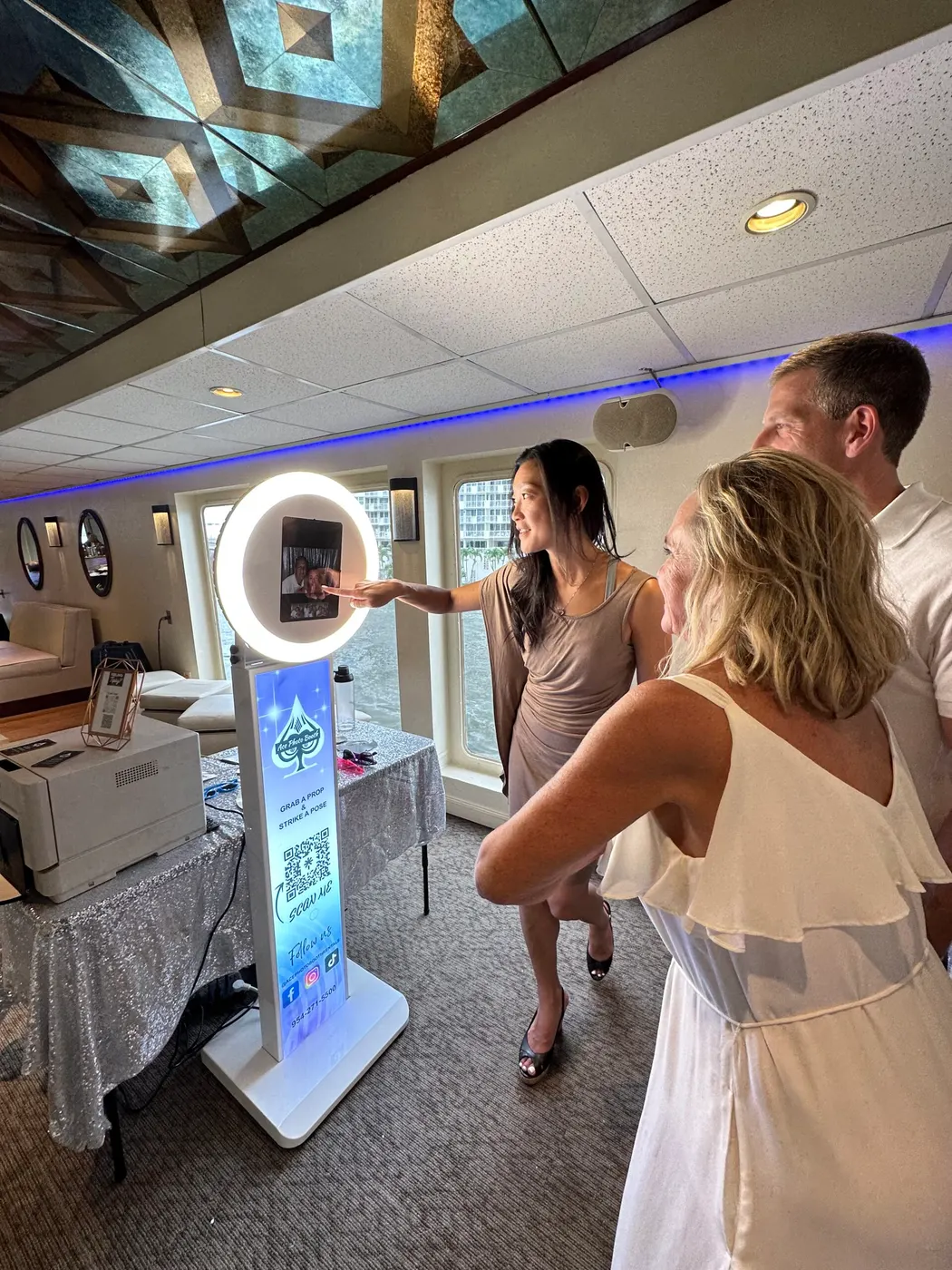 Guests posing at a ring-light digital selfie booth