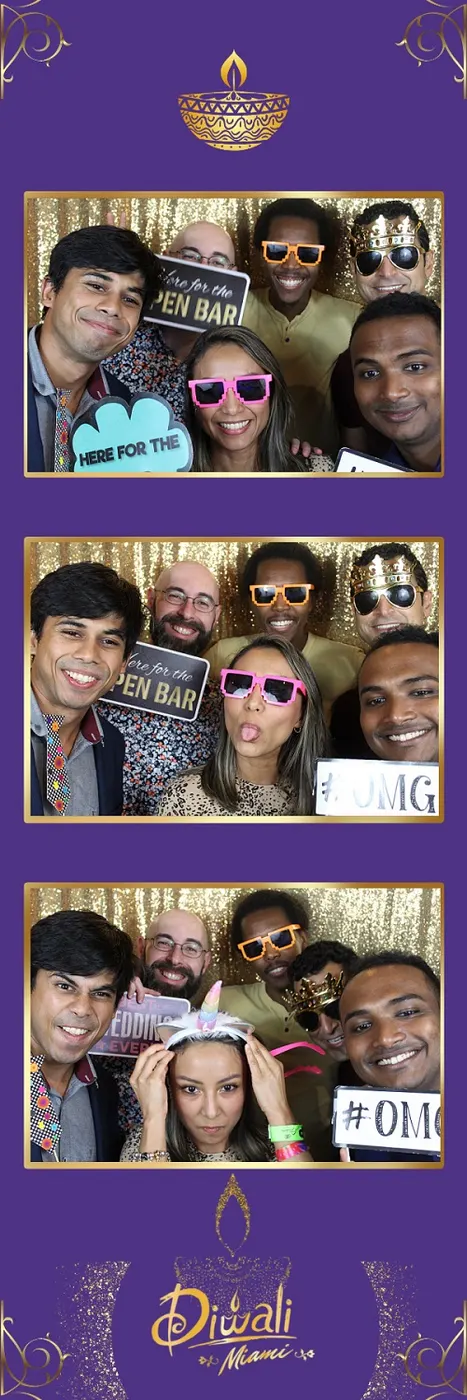 Friends in party glasses posing in a photo booth print strip