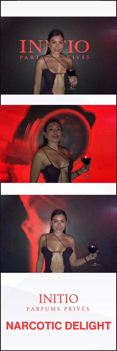 Guest posing under red neon lights at a photo booth